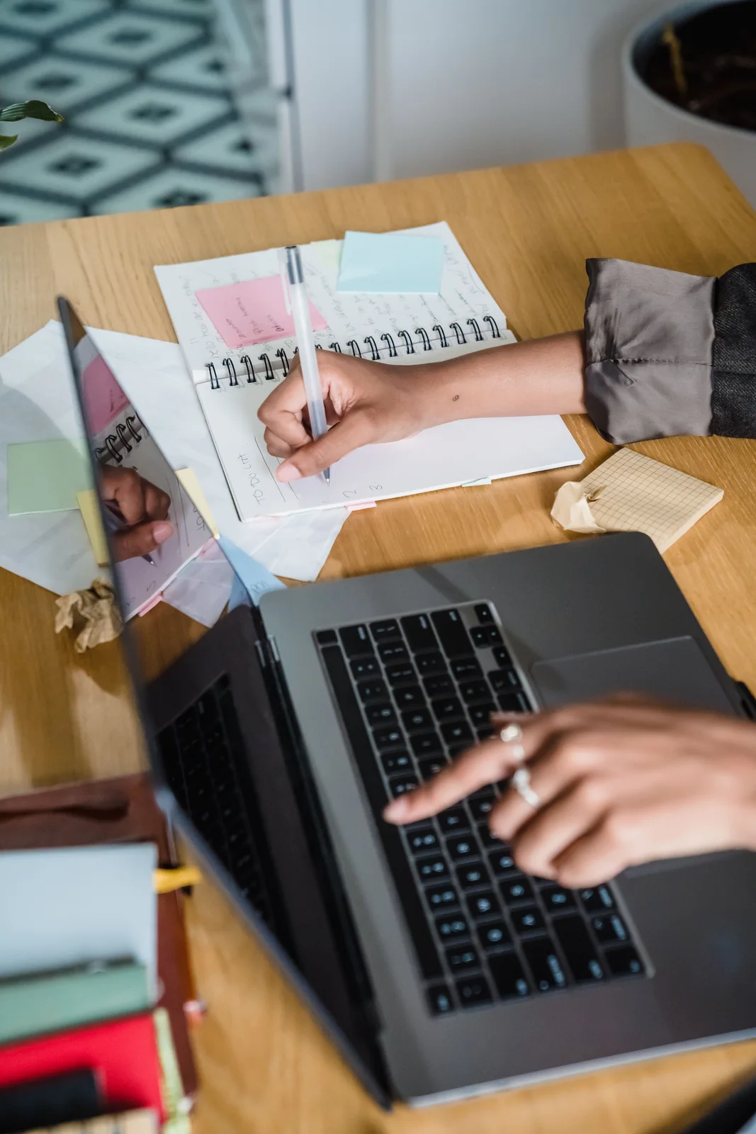 Planning notes beside a laptop — illustrative workspace